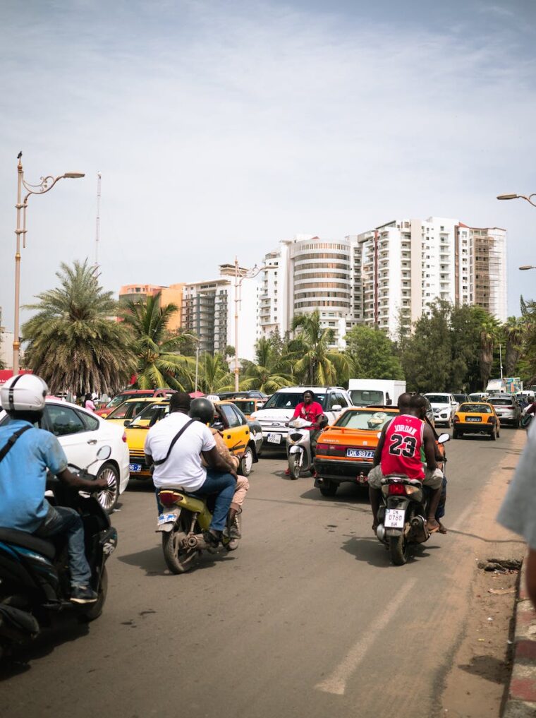 A group of people riding motorcycles on a busy street