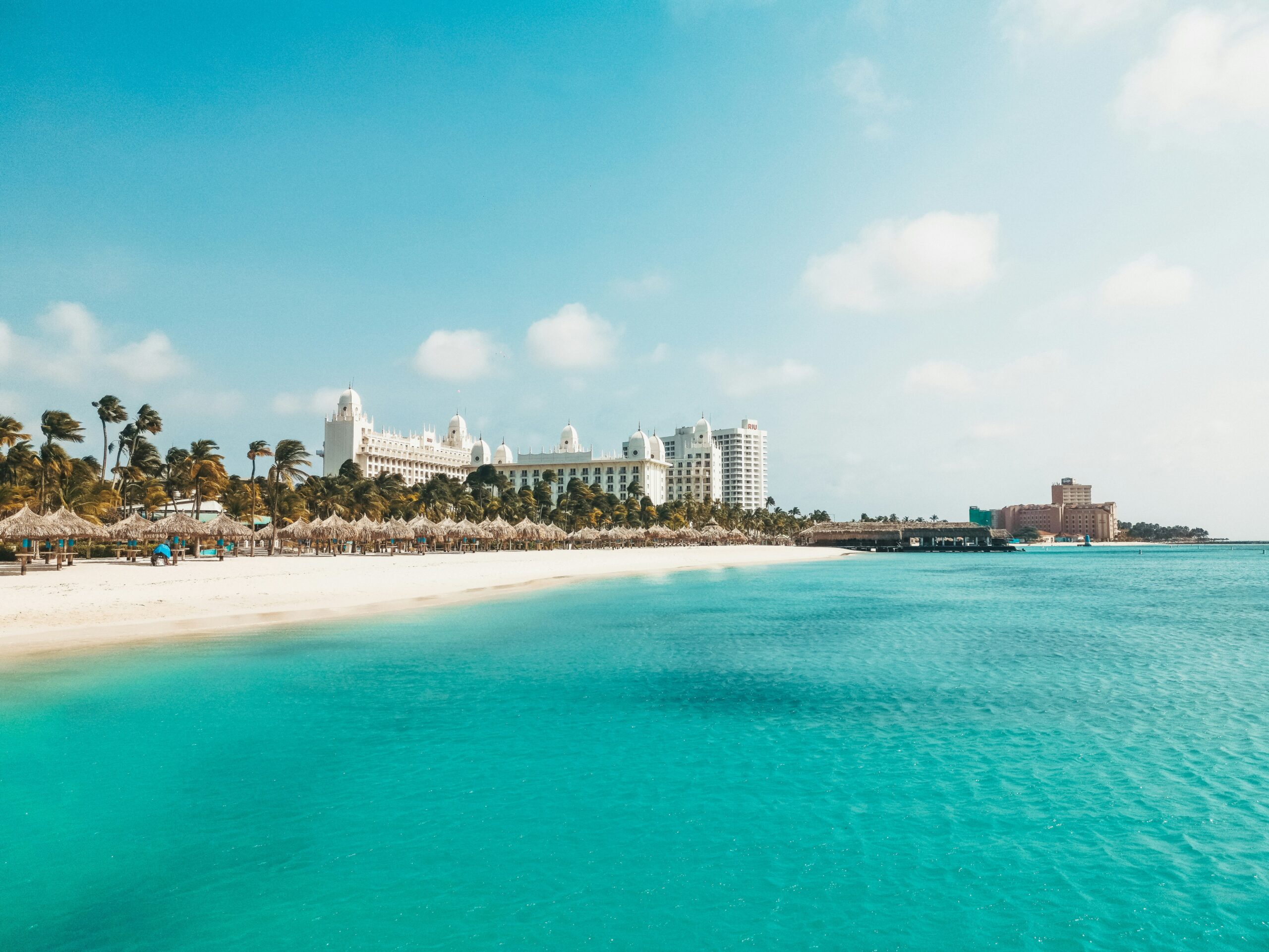 a view of a beach with a hotel in the background