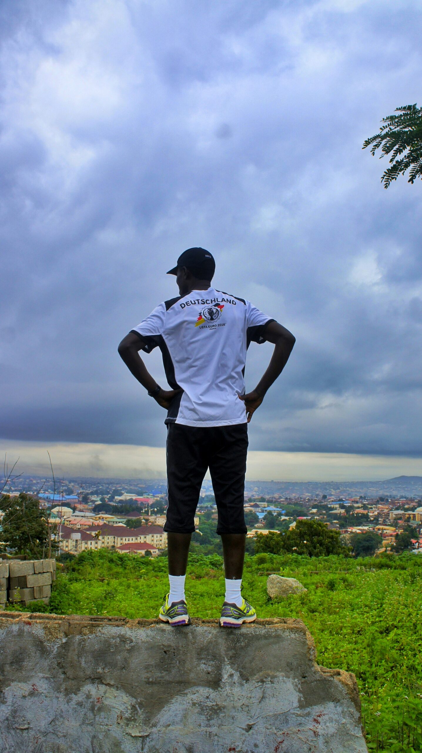 man standing on concrete fence