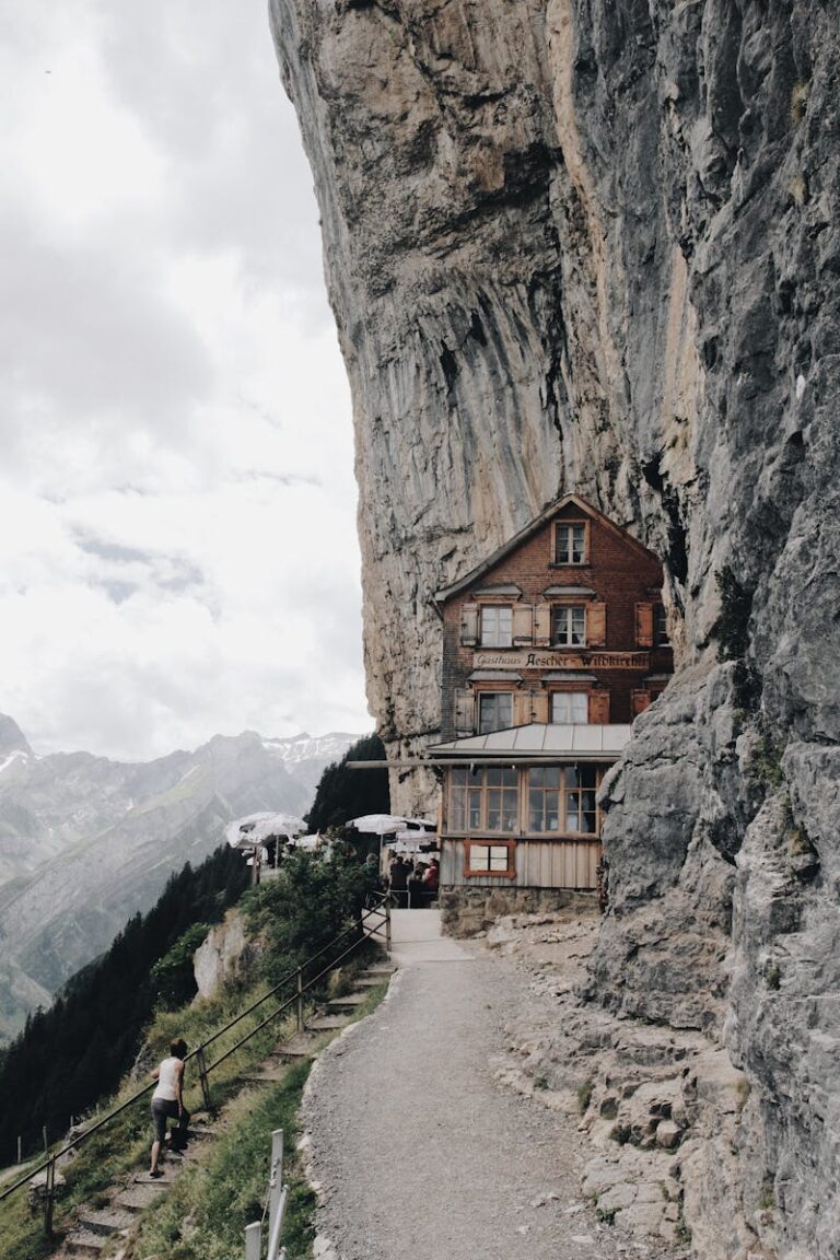 Discover the awe-inspiring cliffside Gasthaus at Ebenalp, nestled in the Swiss Alps' stunning rock formations.