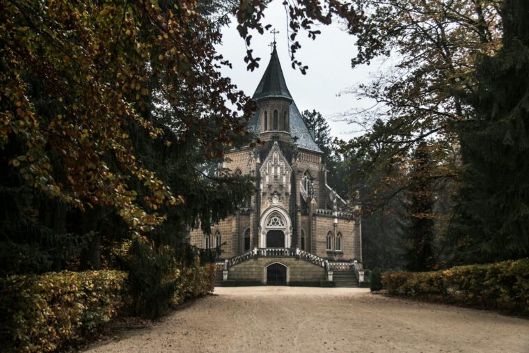 A stunning Gothic Revival chapel nestled in an autumn forest in Třeboň, Czechia.