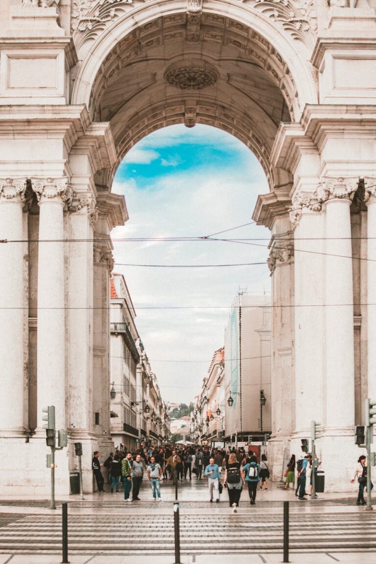 Explore the iconic Lisbon arch and vibrant street filled with tourists, capturing Portugal's rich history.