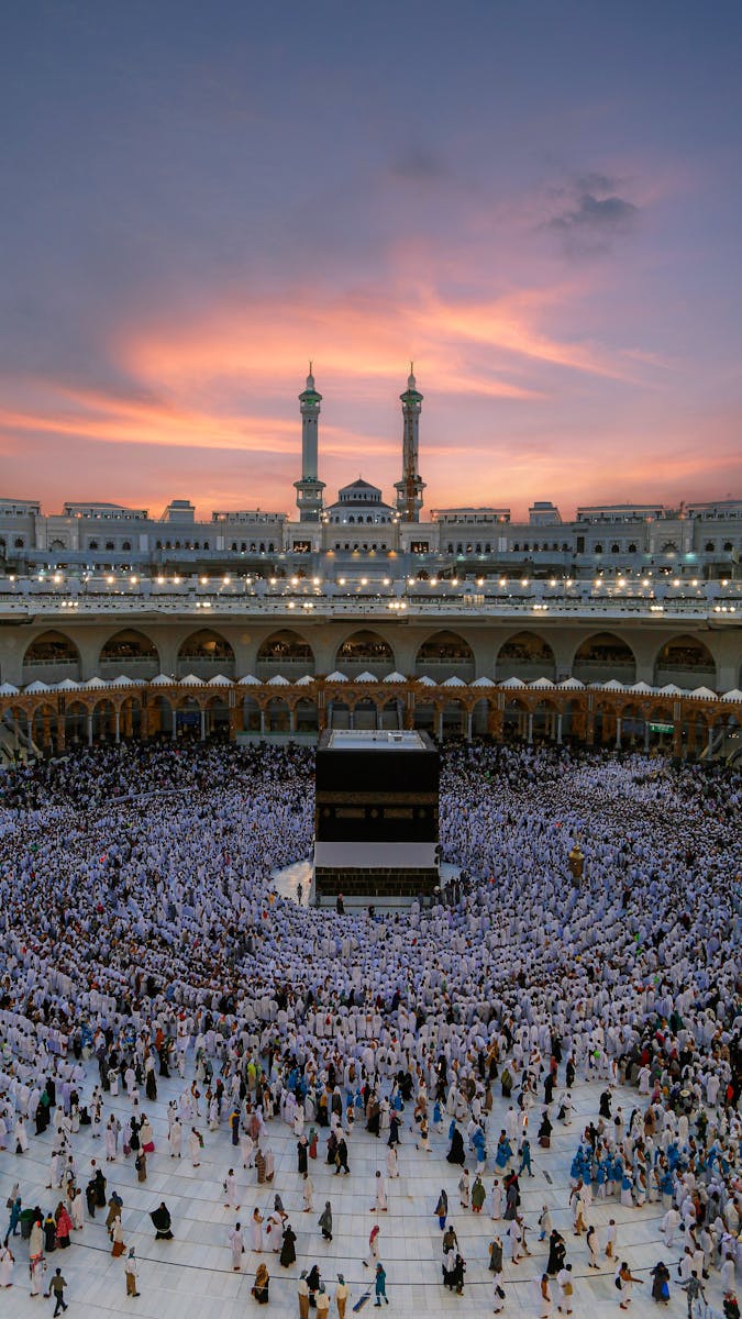 Aerial view of the Kaaba surrounded by worshippers during dusk at the Grand Mosque in Mecca, Saudi Arabia.