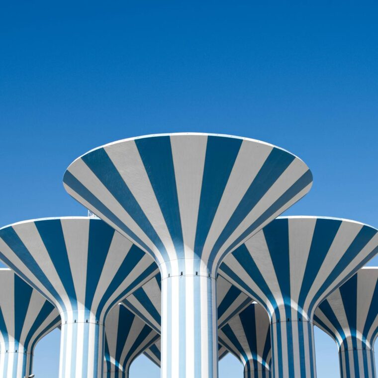 Iconic striped water towers in Kuwait City, under a clear blue sky.