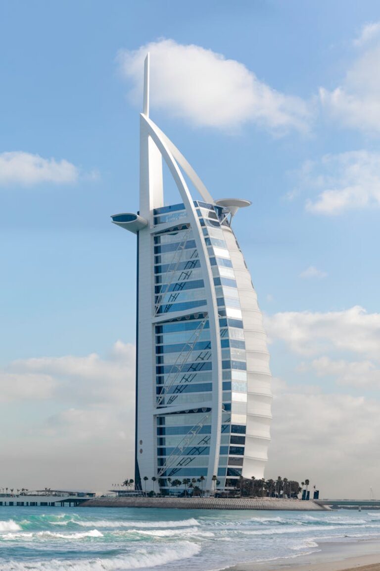 Stunning view of the iconic Burj Al Arab hotel against a clear blue sky in Dubai, UAE.