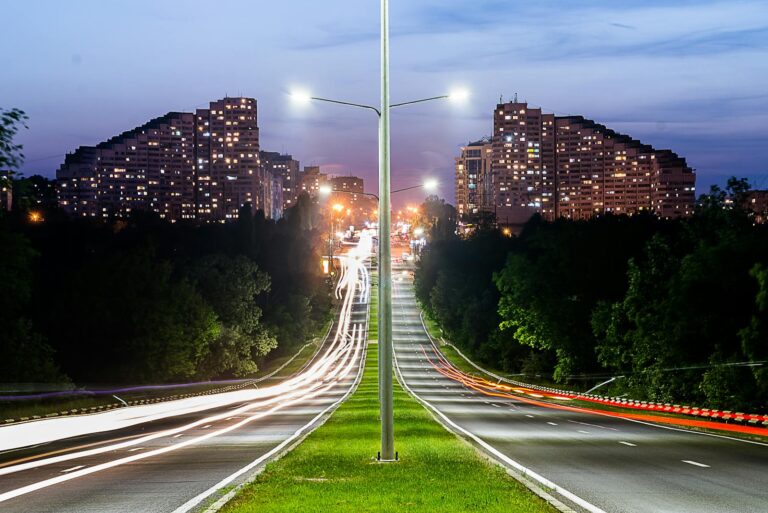 Long exposure of a highway in Chișinău showing light trails and urban skyline at night.