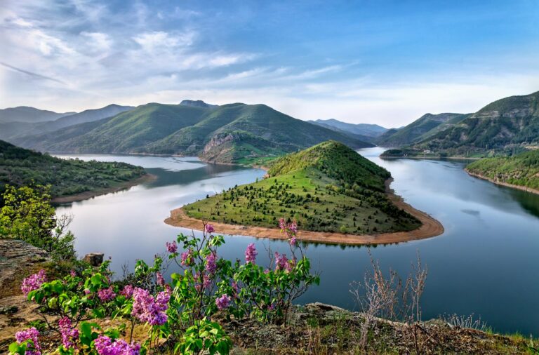 Beautiful view of the Arda River curving through lush green hills on a clear day.