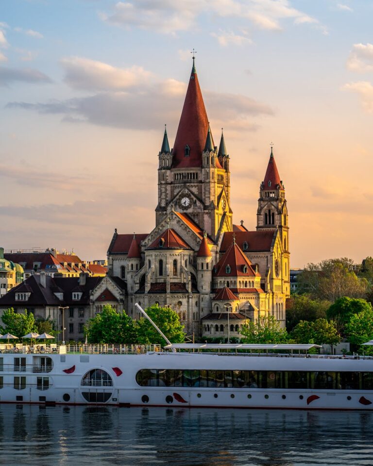 Scenic view of St. Francis of Assisi Church by the river at sunset in Vienna, Austria.