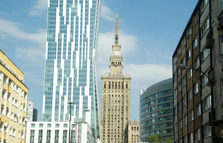 Dynamic view of Warsaw skyline showcasing modern and historical architecture in daylight.