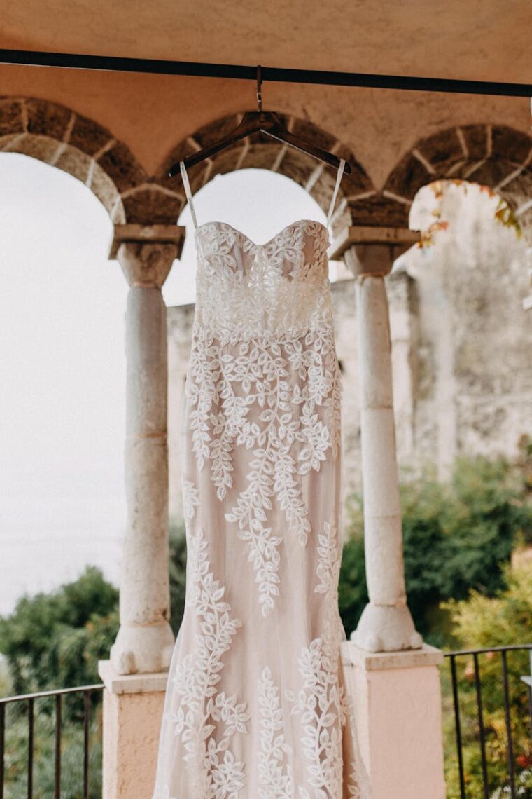 A beautiful lace wedding dress hanging in an archway in Beirut, Lebanon.