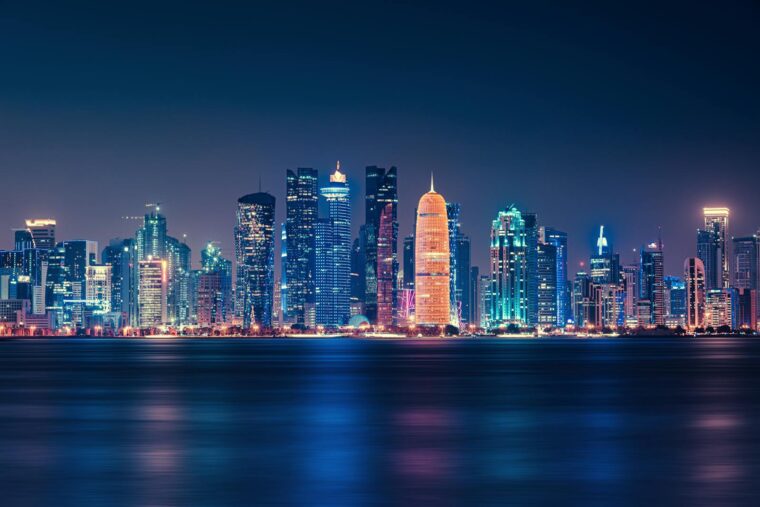 Captivating night view of Doha's illuminated skyline reflecting over the water.