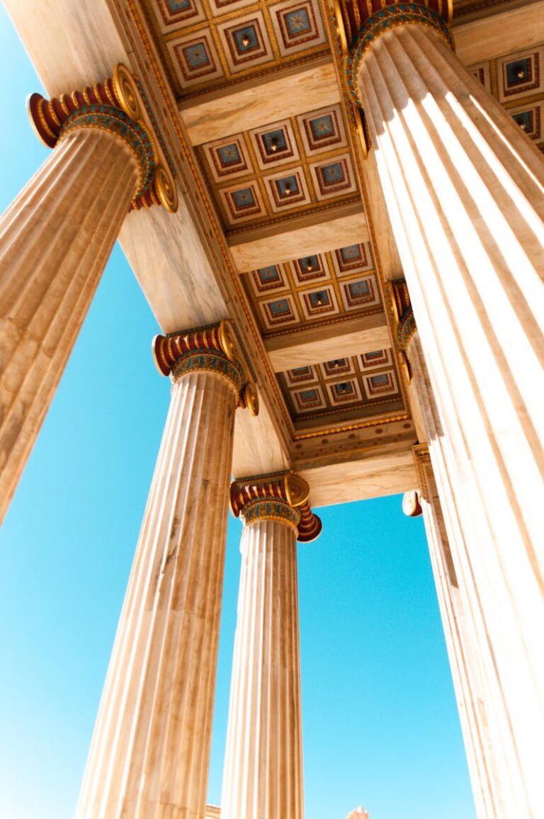 Explore ancient Greek architecture with a low angle view of grand columns in Athens.