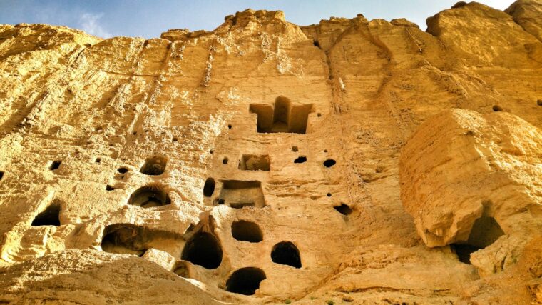 Low angle view of ancient cliff dwellings carved in Bamyan, Afghanistan.