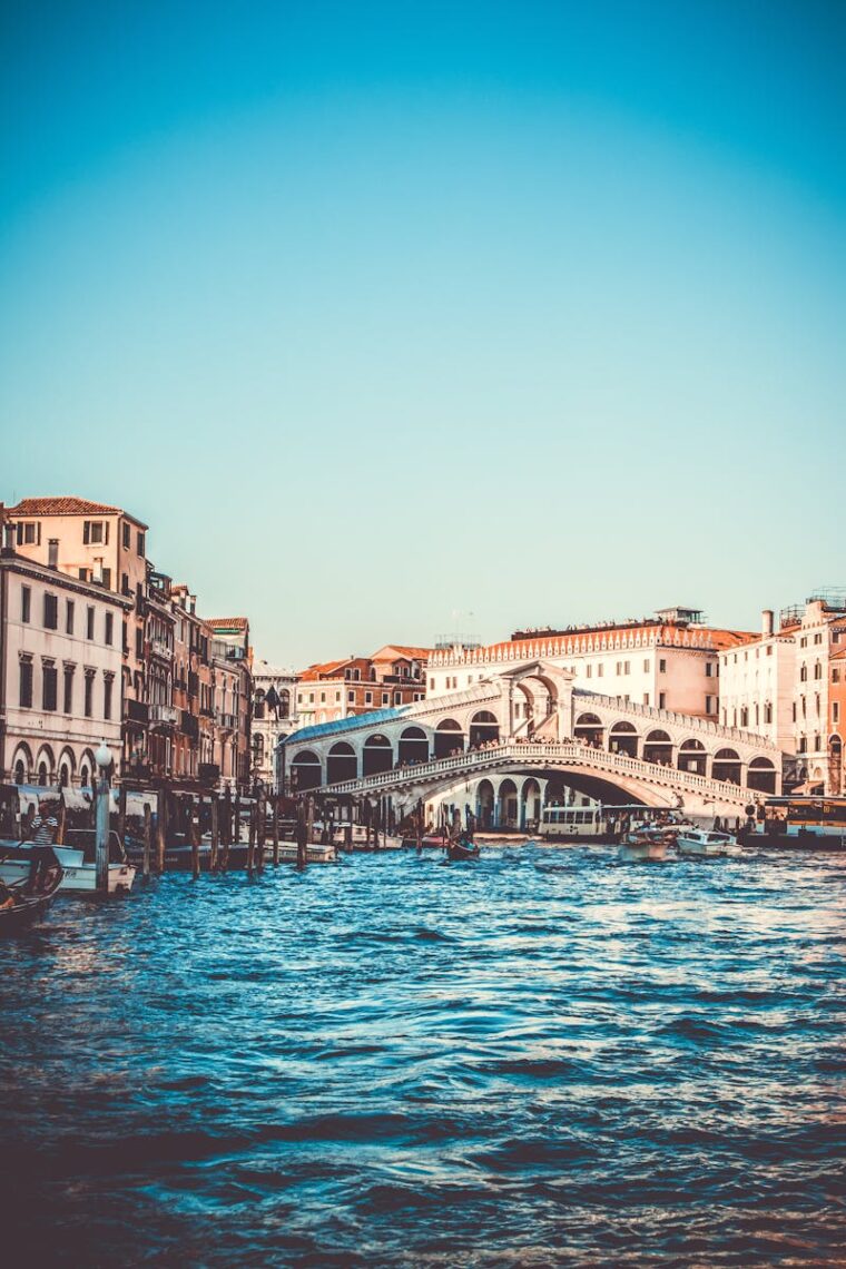 Explore the iconic Rialto Bridge over the Grand Canal in Venice, a must-visit tourist spot.