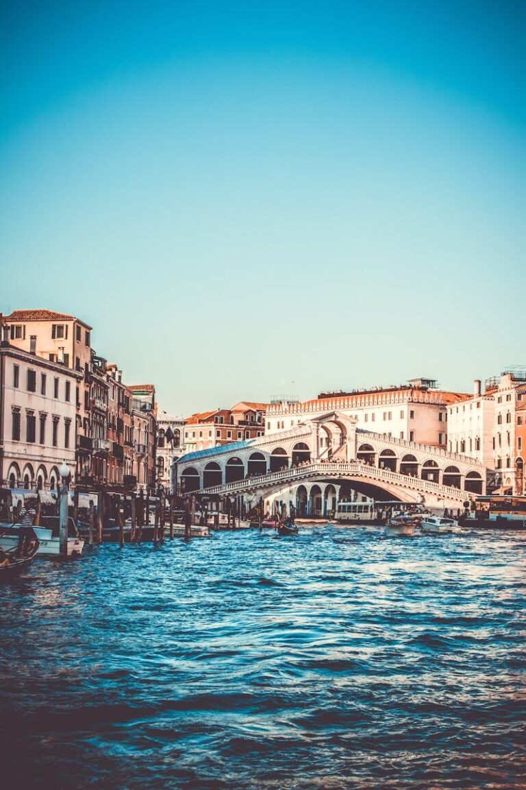 Explore the iconic Rialto Bridge over the Grand Canal in Venice, a must-visit tourist spot.