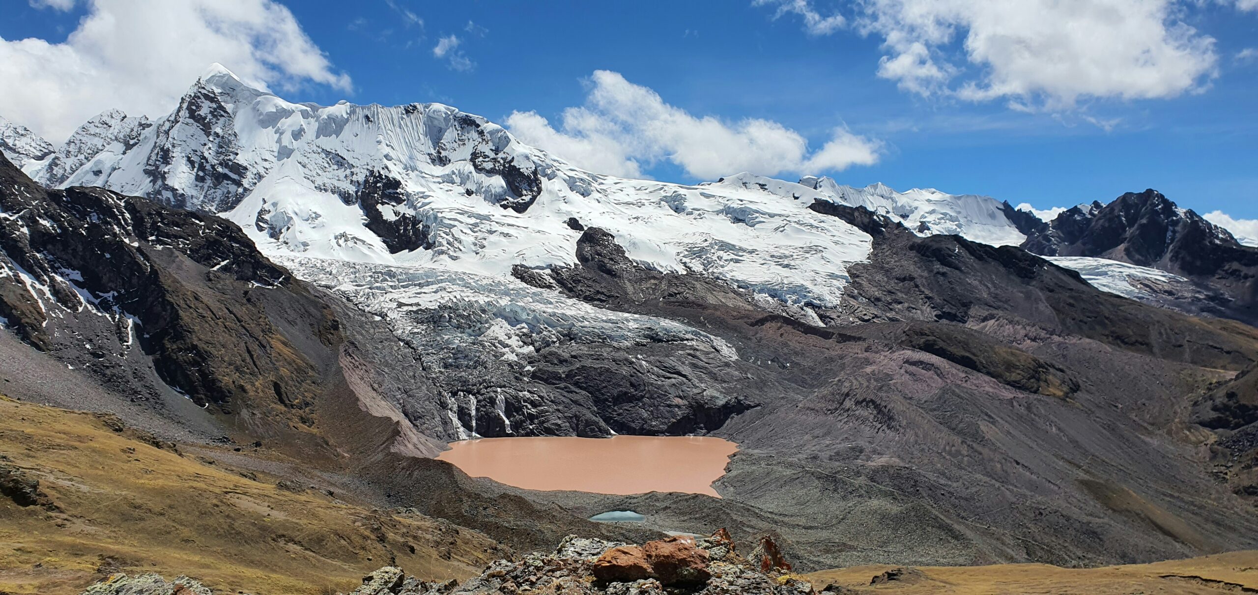 a view of a mountain range with a lake in the foreground