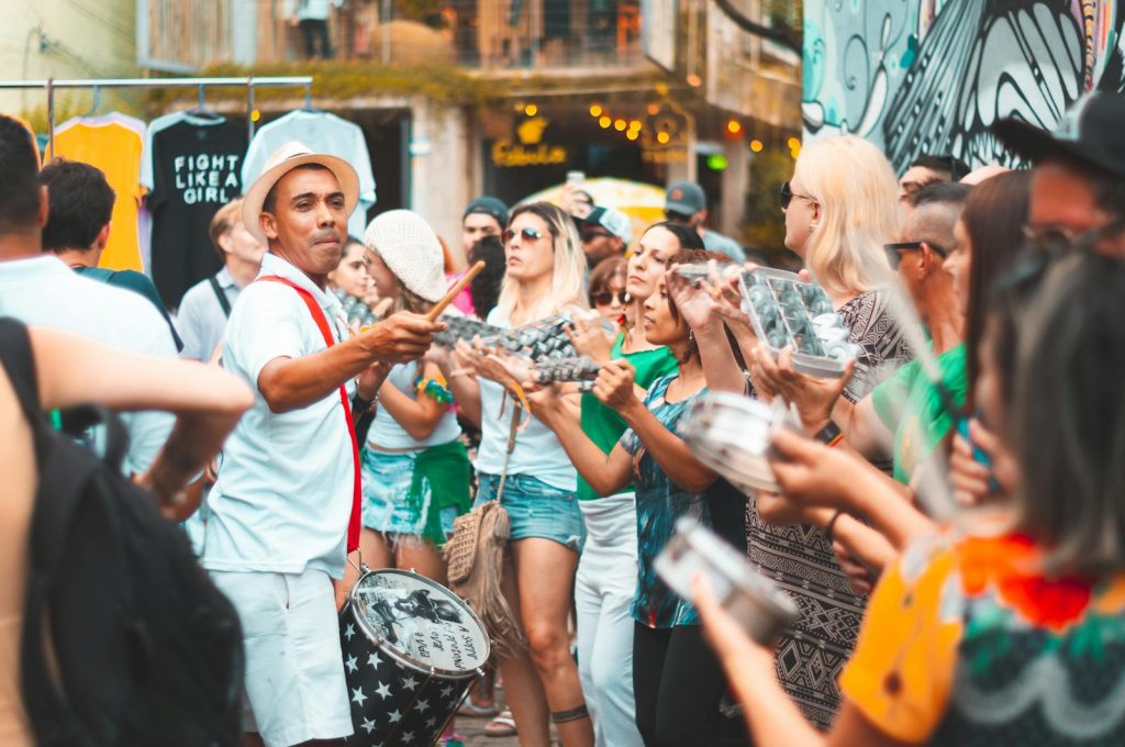 Colorful street parade featuring musicians and lively participants in an outdoor celebration.