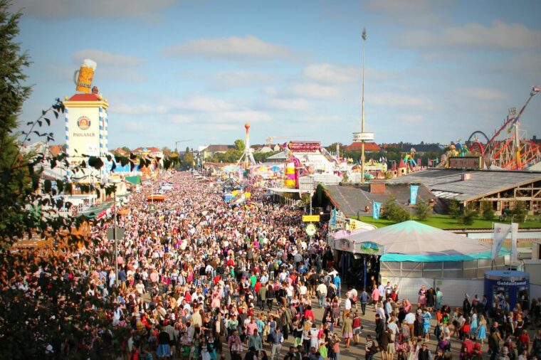 A lively scene at Oktoberfest in Munich with a massive crowd enjoying the festivities and attractions.